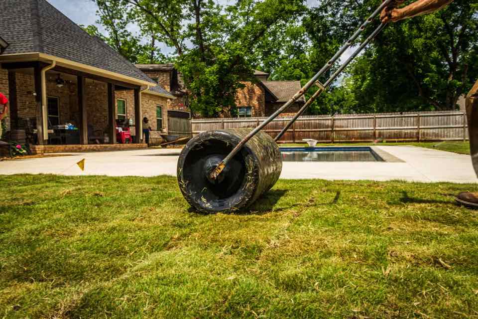 Landscaper improving a green residential backyard